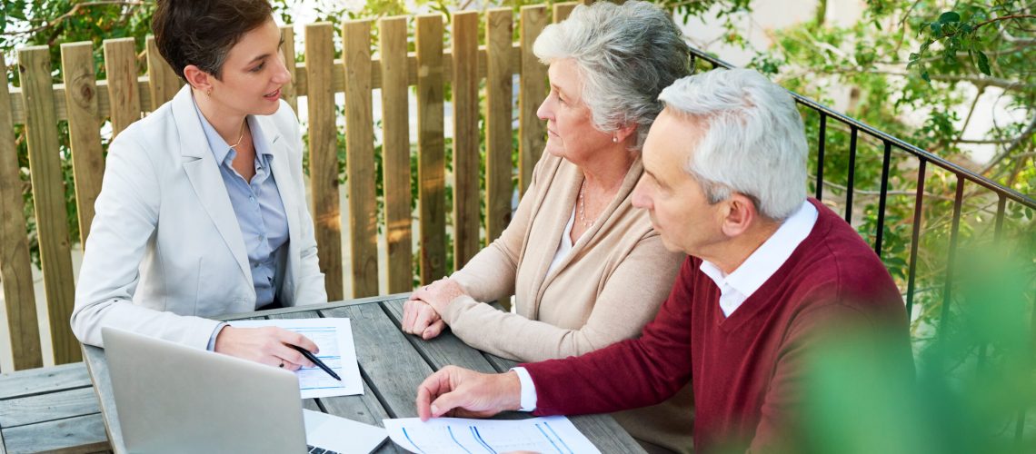 Cropped shot of a senior couple meeting with their financial planner outside