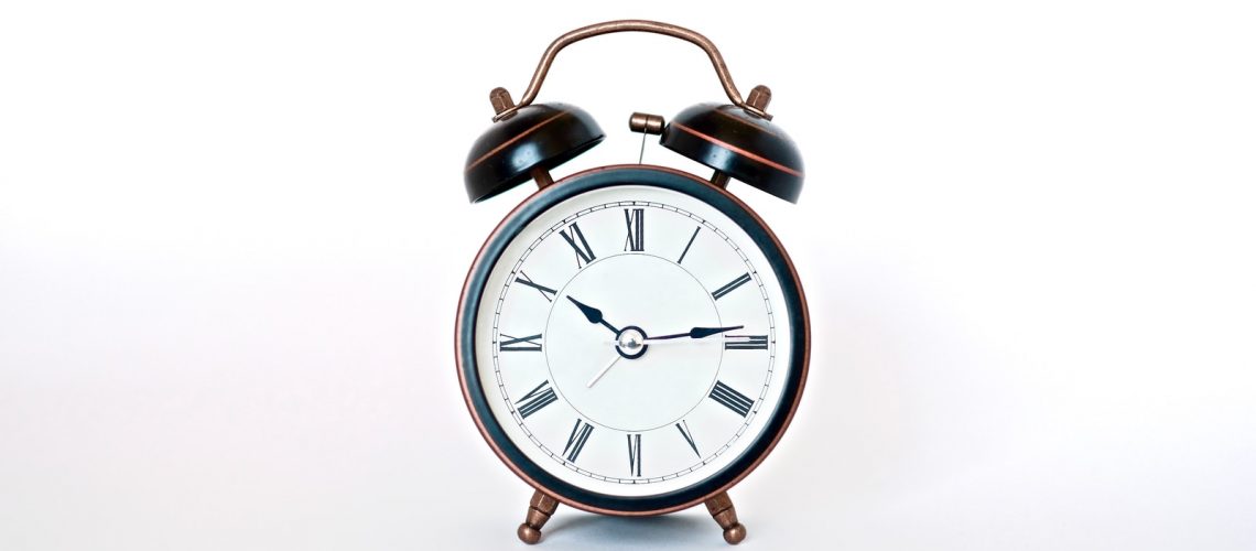 round black and white analog alarm clock